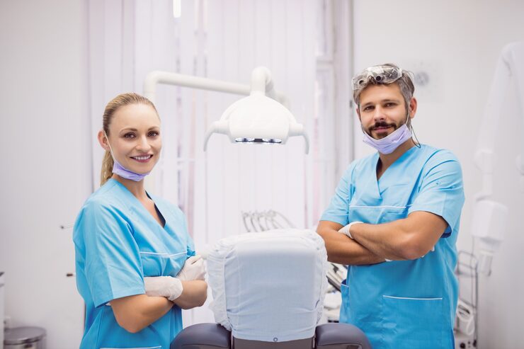 dentist-standing-with-arms-crossed-dental-clinic_107420-65535