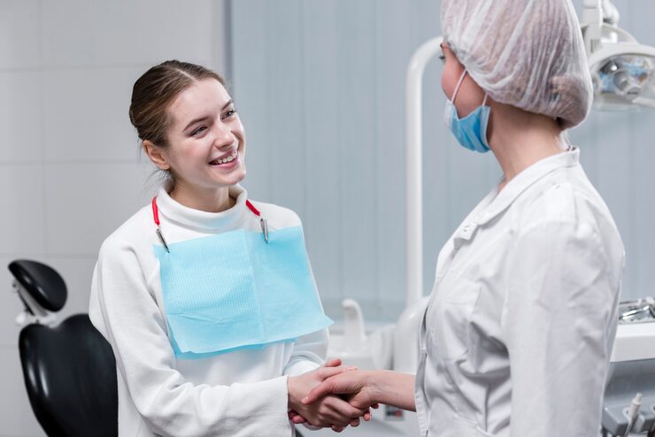 patient-shaking-hand-with-dentist_23-2148396184